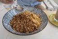 Bowl with granules and coconut and chocolate chips for a healthy breakfast. Male hand with a spoon and a plate with muesli Royalty Free Stock Photo