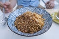 Bowl with granules and coconut and chocolate chips for a healthy breakfast. Male hand with a spoon and a plate with muesli Royalty Free Stock Photo