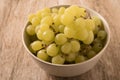 A bowl of grapes on an old wooden background. Royalty Free Stock Photo