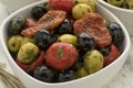 Bowl with green and black olives, peppers and tomatoes Royalty Free Stock Photo