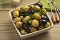 Bowl with green and black olives seasoned with garlic and herbs Royalty Free Stock Photo