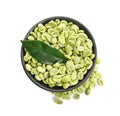 Bowl with green coffee beans and fresh leaf on white background, top view Royalty Free Stock Photo