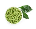 Bowl with green coffee beans and fresh leaf on white background, top view Royalty Free Stock Photo