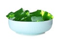 Bowl with green jelly cubes on background