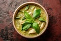 Bowl of Green Soup With Basil Leaves