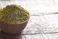 A Bowl of Green Tea Matcha Powder on a Woodn Table