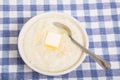 Bowl of Grits with Butter and Spoon