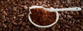 Bowl of ground coffee over roasted coffee beans Royalty Free Stock Photo