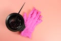 A bowl of hair dye and pink gloves Royalty Free Stock Photo