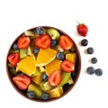 Bowl of healthy fresh fruit salad isolated on white background. Top view Royalty Free Stock Photo