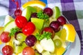 Bowl of healthy fresh fruit salad and milk on pattern of Thai hand made fabric background. Royalty Free Stock Photo