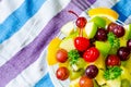 Bowl of healthy fresh fruit salad on pattern of Thai hand made fabric background Royalty Free Stock Photo