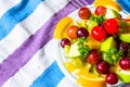 Bowl of healthy fresh fruit salad on pattern of Thai hand made fabric background Royalty Free Stock Photo