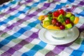 Bowl of healthy fresh fruit salad on pattern of Thai hand made fabric background Royalty Free Stock Photo