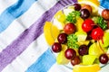 Bowl of healthy fresh fruit salad on pattern of Thai hand made fabric background Royalty Free Stock Photo