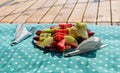 Bowl of healthy fresh fruit salad on pillow and wooden background Royalty Free Stock Photo