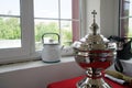 A bowl of holy water stands on a table on the veranda of an Orthodox church Royalty Free Stock Photo