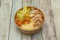 Bowl for home delivery of fried chicken breast in pieces, grated cheese, tomato