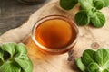 A bowl of homemade Coleus amboinicus syrup with fresh leaves