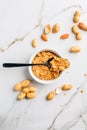 Bowl with homemade crunchy peanut butter and heap of nuts