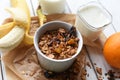 A bowl of homemade granola, a glass of yogurt, fresh fruits and a bottle of milk Royalty Free Stock Photo