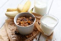 A bowl of homemade granola, a glass of yogurt, fresh fruits and a bottle of milk Royalty Free Stock Photo