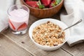 A bowl of homemade granola with yogurt and fresh strawberries on a wooden background. Healthy breakfast Royalty Free Stock Photo