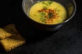 Bowl of homemade lentil soup in a black soup bowl with two toast breads, close up Royalty Free Stock Photo