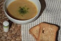 Bowl of homemade lentil soup in a porcelain  soup bowl with two slice of breads, close up Royalty Free Stock Photo