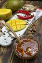 Bowl of homemade Mango Chutney on old wooden table Royalty Free Stock Photo