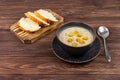 A bowl of homemade mushroom cream soup with bread on a wooden table. Homemade vegetarian mushroom soup with vegetables Royalty Free Stock Photo
