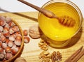 Bowl with honey and basket with hazelnuts on wooden table Royalty Free Stock Photo