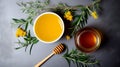 Bowl of honey, jar of honey, dipper, and wildflowers on grey stone background Royalty Free Stock Photo