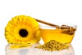 Bowl of honey near a pile of pollen and flower