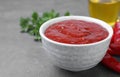 Bowl of hot chili sauce and ingredients on table, closeup Royalty Free Stock Photo