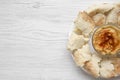 Bowl of Hummus with chickpeas, paprika, olive oil and pita bread on white plate over white wooden surface, top view. From above, o Royalty Free Stock Photo