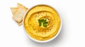 Bowl of hummus with greens on simple background
