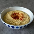 Bowl with hummus topped with olive oil and paprika Royalty Free Stock Photo