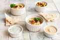 Bowl of hummus, traditional Jewish, Arabian, Middle Eastern food from chick-peas with deeps and with pita flatbread on ceramic