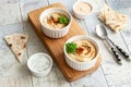Bowl of hummus, traditional Jewish, Arabian, Middle Eastern food from chick-peas with deeps and with pita flatbread on ceramic