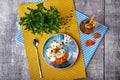 A bowl of ice cream, a bottle of apricot juice and decorative tree on a wooden background. Top view of a light dinner.