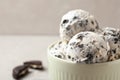 Bowl with ice cream and crumbled chocolate cookies on table, closeup Royalty Free Stock Photo