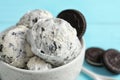 Bowl with ice cream and crumbled chocolate cookies on table, closeup Royalty Free Stock Photo