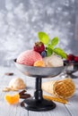 Bowl with ice cream with three different scoops of white, yellow, red colors and waffle cone, chocolate, tangerines and Royalty Free Stock Photo