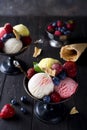 Bowl with ice cream with three different scoops of white, yellow, red colors and waffle cone Royalty Free Stock Photo