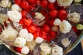 A bowl of ice cubes with frozen flowers and berries. Royalty Free Stock Photo