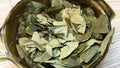 Bowl of Inca coca leaves on table restaurant in Cusco, Peru.