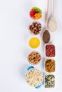 Bowl with ingredients for cooking homemade granola on white background. Healthy snak.