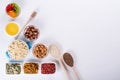 Bowl with ingredients for cooking homemade granola on white background. Healthy snak.