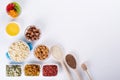 Bowl with ingredients for cooking homemade granola on white background. Healthy snak.